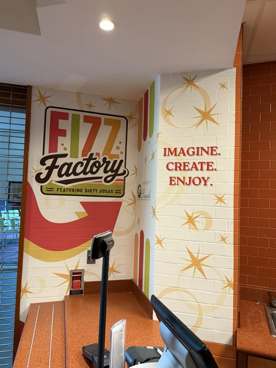 Colorful Fizz Factory soda shop graphics on interior walls